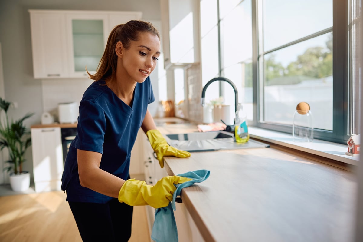 Professional cleaner in a modern kitchen
